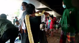 children under a snake while playing in a crowded place