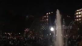 Newsflare Edit - Man waves flag above crowd at Washington Square Park Fountain