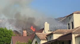 Helicopter drops water on Grandview Brush Fire in California