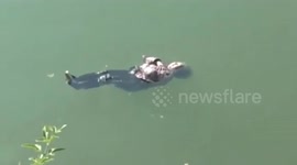 Firefighters save elderly Chinese woman floating on river after accidentally falling in