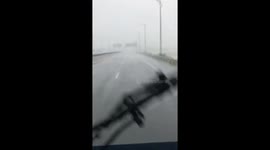 Truck drives through heavy rain and strong winds as Tropical Storm Etau makes landfall in central Vietnam