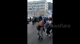 Peruvian protestors run as police fire tear gas during protest against impeachment of President Martín Vizcarra