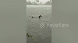 Villagers wade through floods as Typhoon Vamco hits Philippines