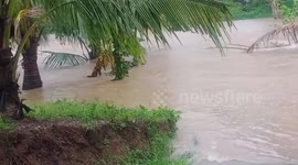 River overflows and blocks roads as Typhoon Vamco hits Philippines