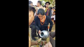 Nagaland Hornbill Festival - Native women pouring rice wine for tribe mens