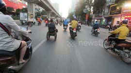 Man with bipedal paralysis recklessly drive wheelchair on crowded streets of Vietnam