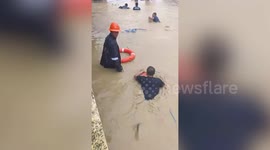 Rescuers Float In Rubber Rings As Typhoon Vamco Floods The Philippines