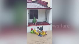 Typhoon Vamco: Moment rescuers pull stranded family into dinghy in Philippines