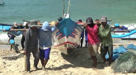 Fishermen lift their boat