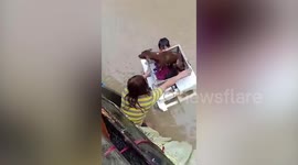 Boy rescues dog from flood using polystyrene 'boat' as Typhoon Vamvo batters Philippines