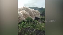 River surges through dam in Philippines as Typhoon Vamco flooding kills dozens