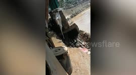 Concrete wall collapses after being battered by Typhoon Vamco in the Philippines