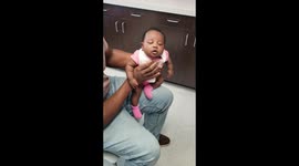 Two-month-old baby in Florida reacts after getting her ears pierced