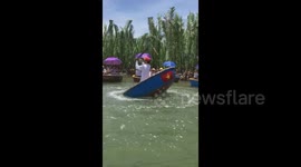 Vietnamese boatman takes tourists for a spin as he whirls raft around