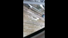 Aftermath of the flood, muddy road. Struggling vehicles