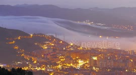 Stunning footage of low clouds and fog rolling across the city of Barcelona at sunrise