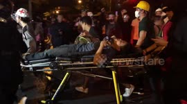 Injured protesters carried away in stretchers after clashes with police in Thailand