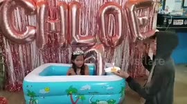Girl celebrates seventh birthday in flooded home after Typhoon Vamco in the Philippines