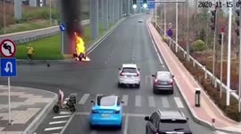 Delivery driver drags motorcyclist away after bike catches fire in northern China