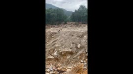 Huge 40-metre-deep crater caused by Typhoon Vamco leaves Vietnamese village isolated