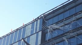 Paris garbage collectors drop flyers from rooftop of local government building