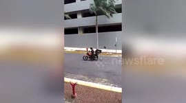 Motorcyclist, pedestrian battle powerful winds from Hurricane Iota