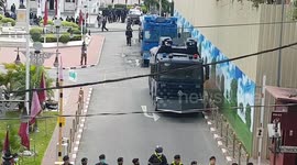 Angry demonstrators tossing paint at police headquarters during an anti-government protest in Bangkok, Thailand
