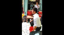 Eye-watering weights: Vietnamese man lifts buckets of water with eyelids in bizarre stunt