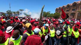 South African police use teargas and stun grenades against members of the 'Economic Freedom Fighters'