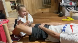 Adorable moment tiny girl tries to put a nappy on her uncle