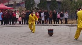 Elderly men play with huge spinning top in China
