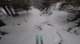 Skier crashes over edge of frozen waterfall