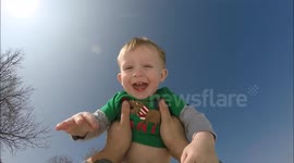 Dad tosses baby with mounted camera