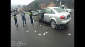 Angry driver throws cash at police during stop in China