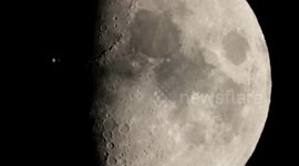International Space Station seen flying in front of the moon