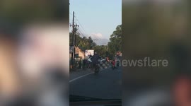 Motorbike Rider Carries Second Bike On His Lap