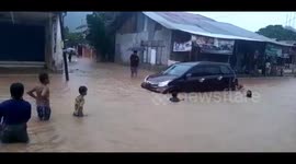 Heavy rain turns streets to swimming pools for kids in Indonesia