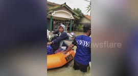 Rescuers evacuate stranded residents after heavy rain causes flooding in Indonesia