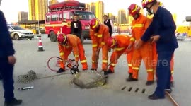 Chinese firefighters rescue man trapped in manhole after drivers spot fingers poking out cover