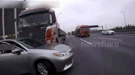 Car gets dragged hundred metres along highway by truck after sudden lane change