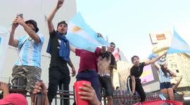 Maradona fans chant and wave flags at the Obelisk in Buenos Aires in tribute