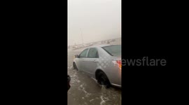 Vehicles drive through flooded highway as storm hits Saudi Arabia