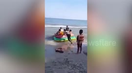 Inflatable boat being pulled by jet ski hits girl playing on beach in Thailand