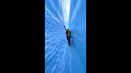 Look away if you're claustrophobic! Alpinists take a morning stroll through narrow glacier crack