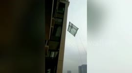 Moment glass window falls 100m to ground from apartment building in China