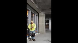Ironworker plays native American flute in lunch break in empty skyscraper