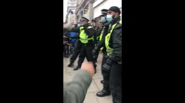 Police pin down protester in stand-off at London anti-lockdown demo