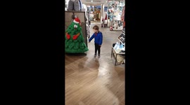Kid dancing with christmas tree