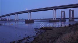 Nearly full Moon rising over Sheppey Crossing in Swale, UK