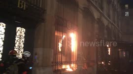 Protesters set fire to brasserie during clashes over security bill in Paris